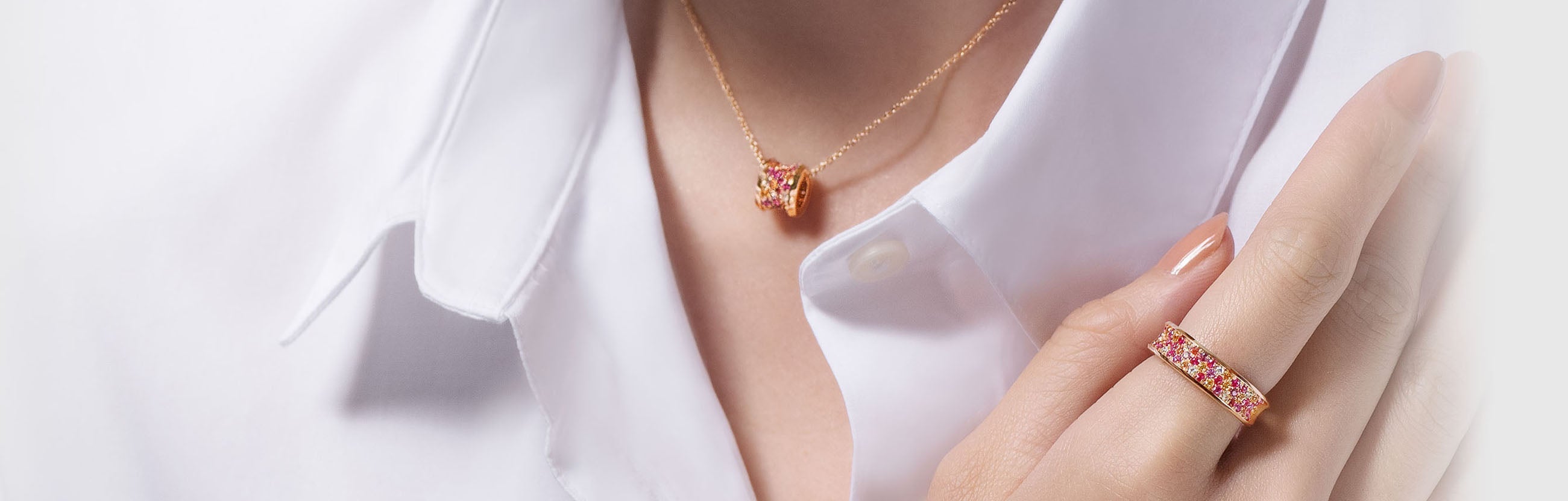 lady wearing a Adamar Jewels Vistoso galaxy necklace and ring in 18K rose gold with colour sapphire and diamonds