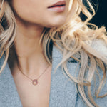 Lady wearing a Adamar Jewels VISTOSO Reflection Necklace in 18K rose gold with colour sapphire and diamonds