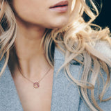 Lady wearing a Adamar Jewels VISTOSO Reflection Necklace in 18K rose gold with colour sapphire and diamonds