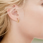 Lady wearing a Adamar Jewels VISTOSO Hoop Earrings, Mini in 18K yellow gold with colour sapphire and diamonds