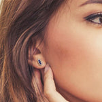 Lady wearing a Adamar Jewels CREENCIA Siempre Earrings in 18K white gold set with sapphire and diamonds